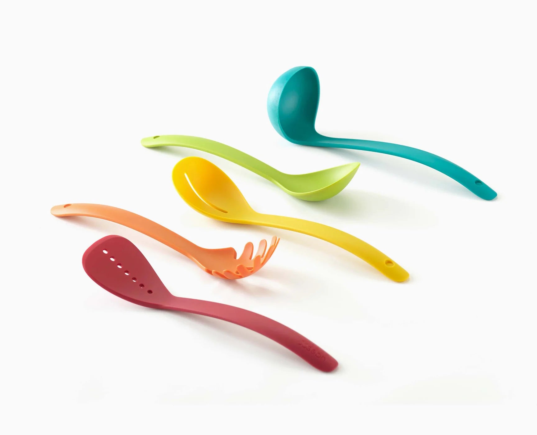 Five multicolour silicone cooking utensils laid out, including spatula, ladle, and fork shapes.