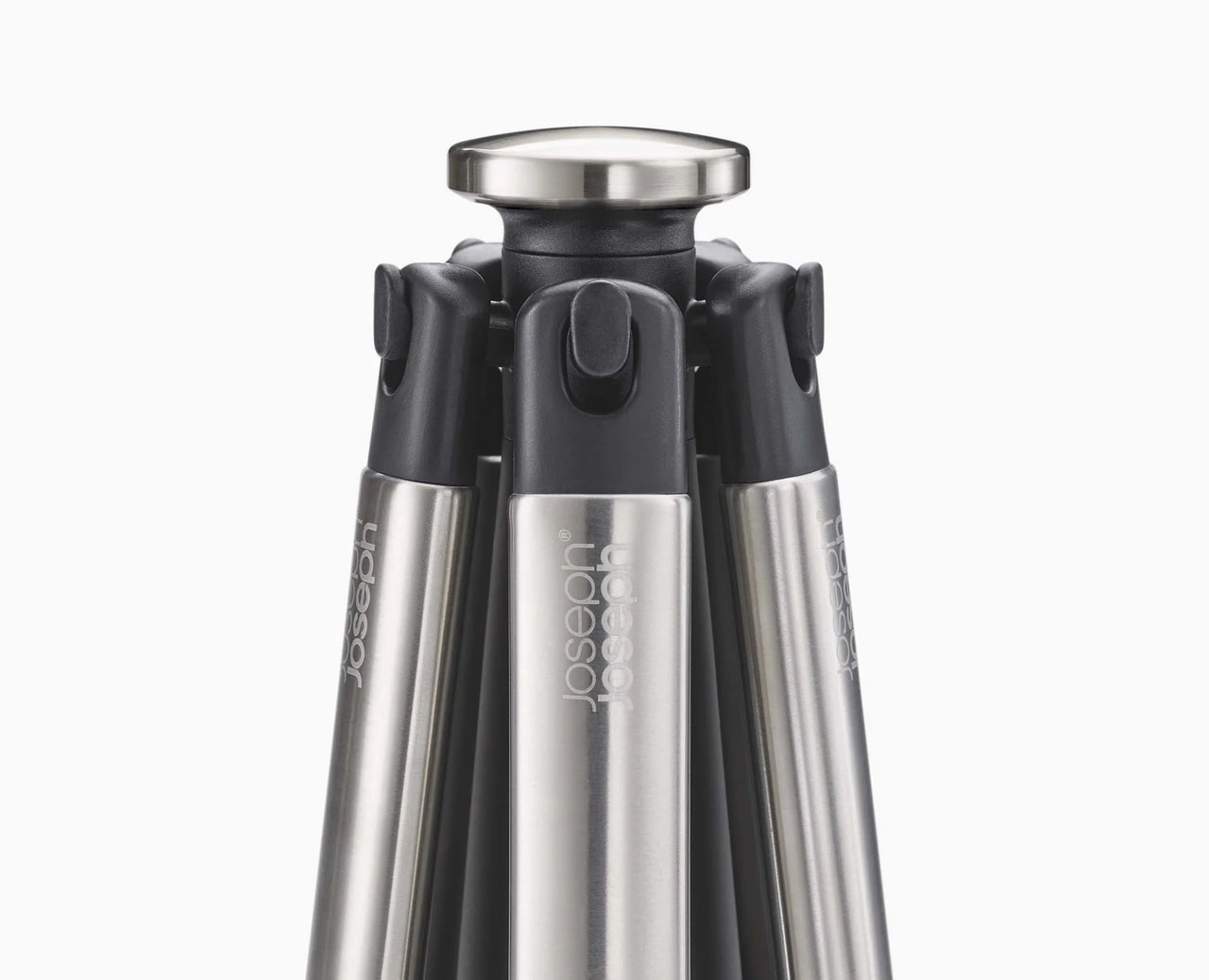 Black utensil carousel with stainless top and five slots for tools