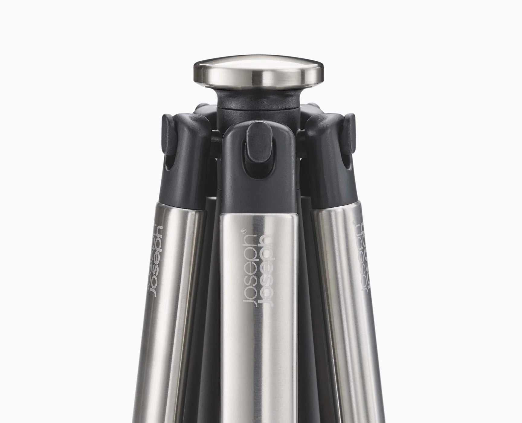 Black utensil carousel with stainless top and five slots for tools