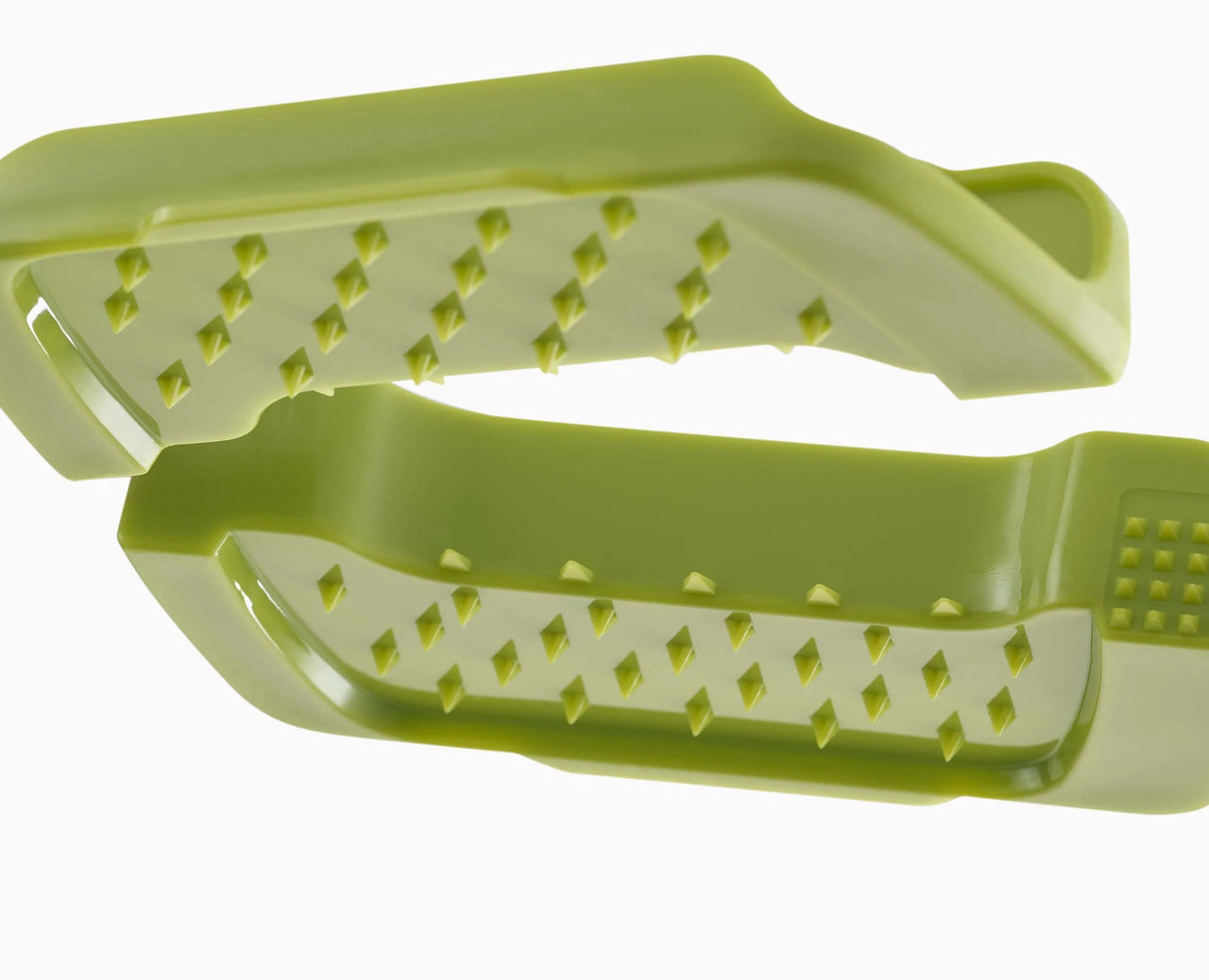 Green food-grip carriage with ridged slice slots for safer vegetable handling