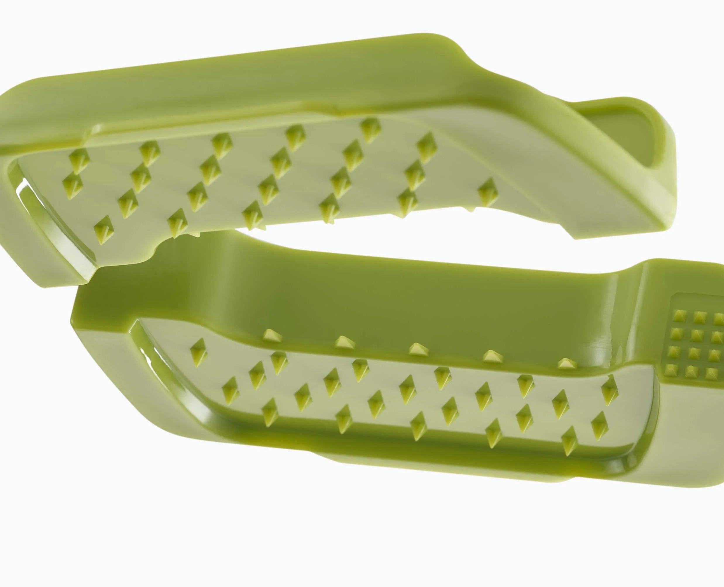 Green food-grip carriage with ridged slice slots for safer vegetable handling