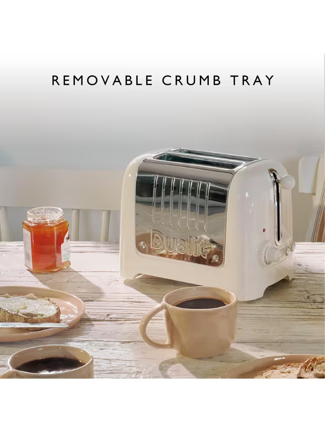 Canvas white toaster with removable crumb tray open, mugs on counter