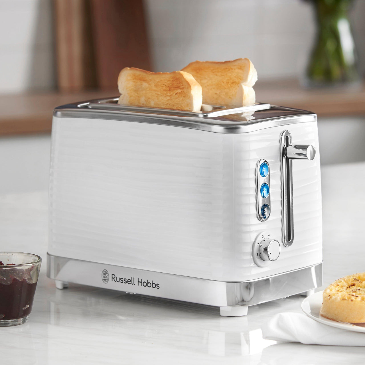 White 2-slice toaster with toast slices loaded in the slots