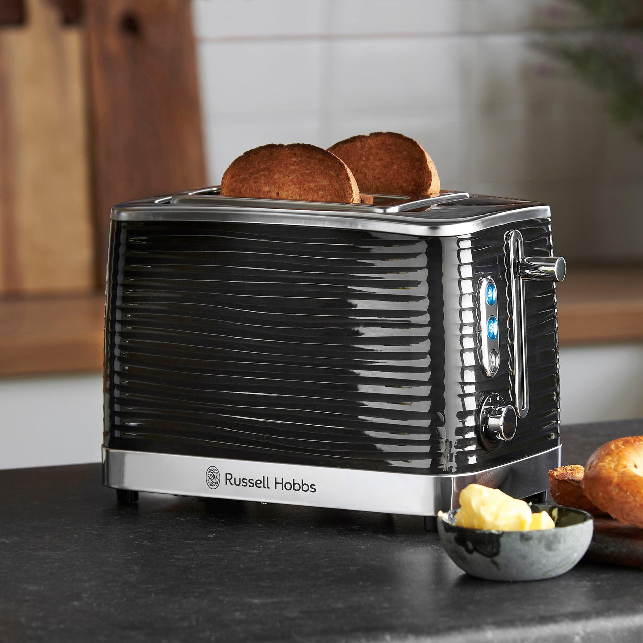 Front view of black 2-slice toaster with two slices of toast