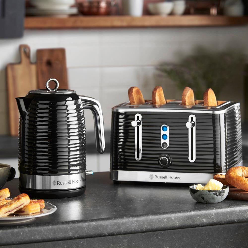 Black 4-slice toaster and kettle on kitchen counter, both with shiny stainless accents