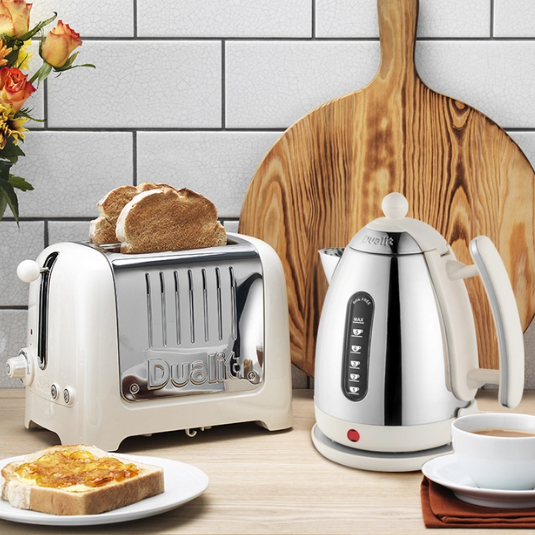 Canvas white toaster with toast slice on plate beside white electric kettle