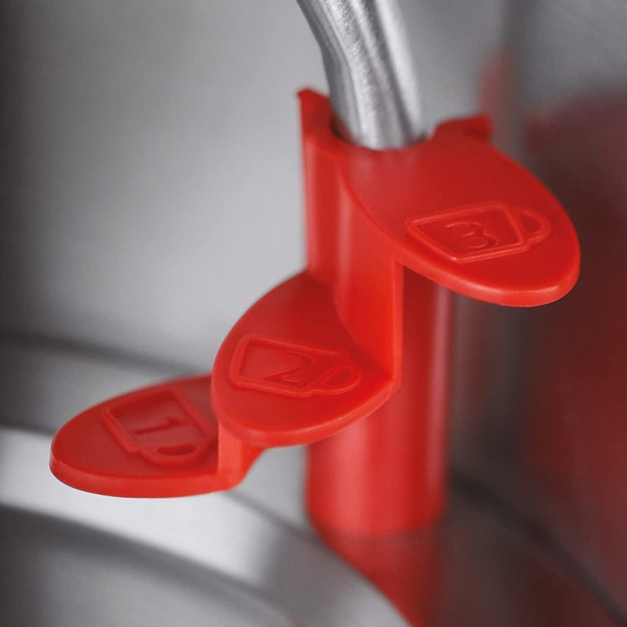 Red safety switch on base of a black electric kettle