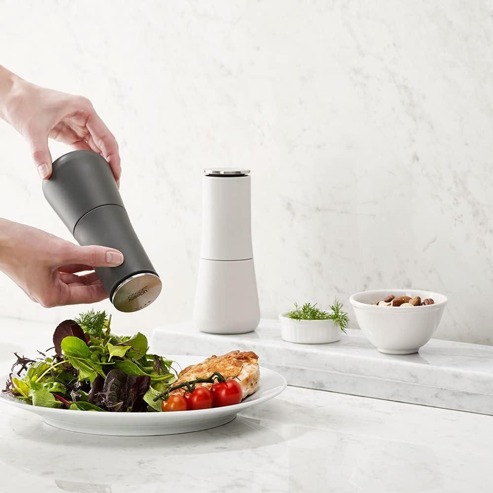 Non-spill salt and pepper mills, dark grey and white, with hand dispensing