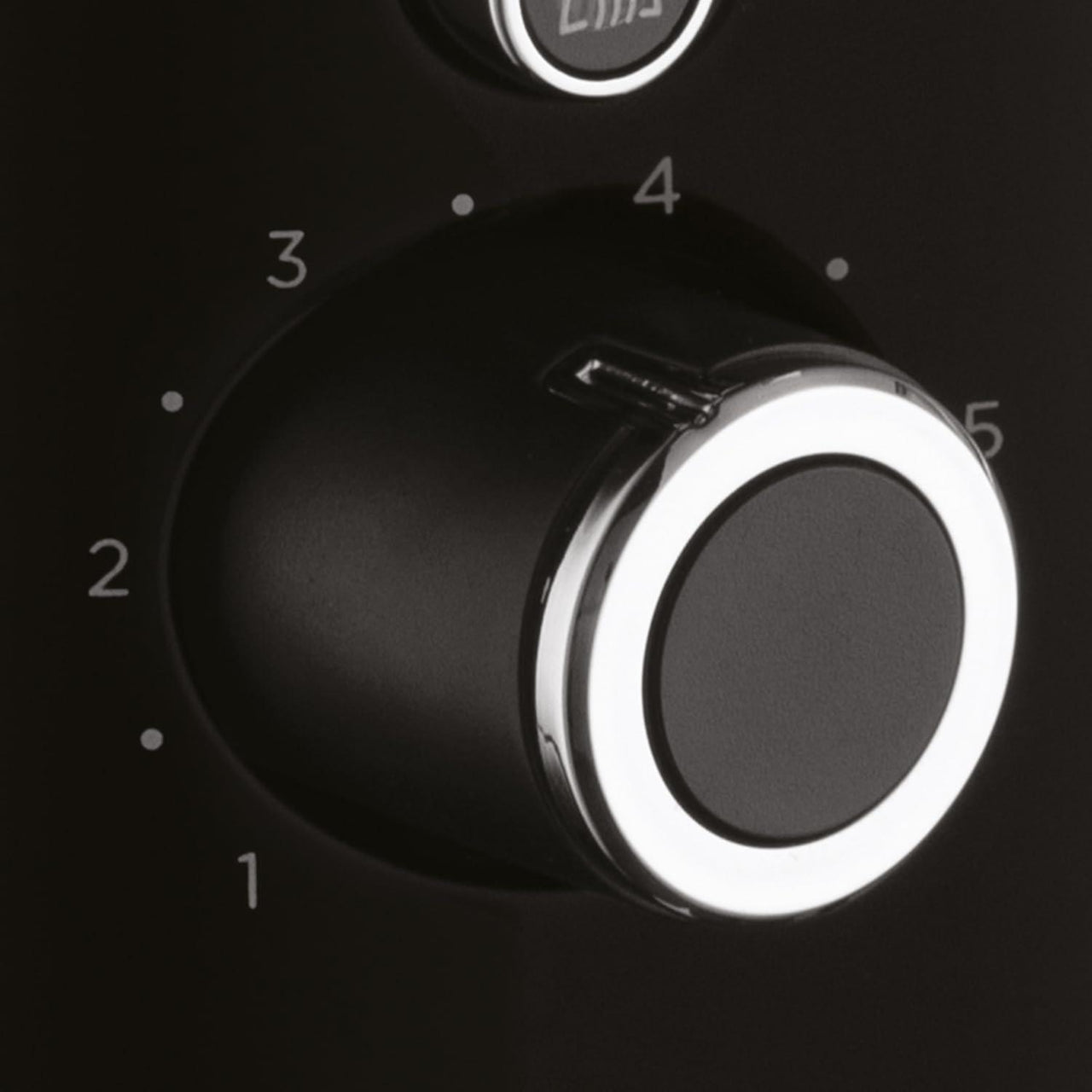 Black toaster temperature dial with numbered settings and silver control ring