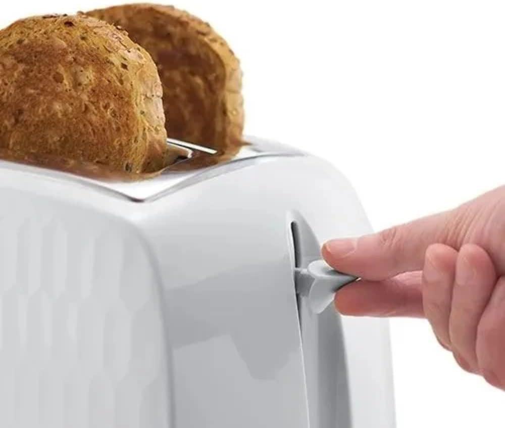 White toaster with bread loaves in the slots, hand lifting the lever
