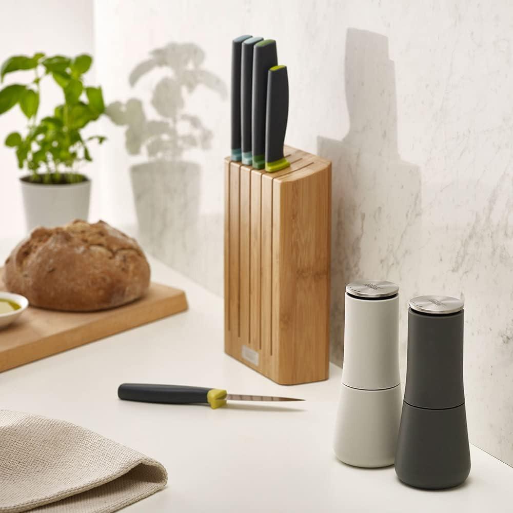 Non-spill salt and pepper mills set, white and dark grey on countertop