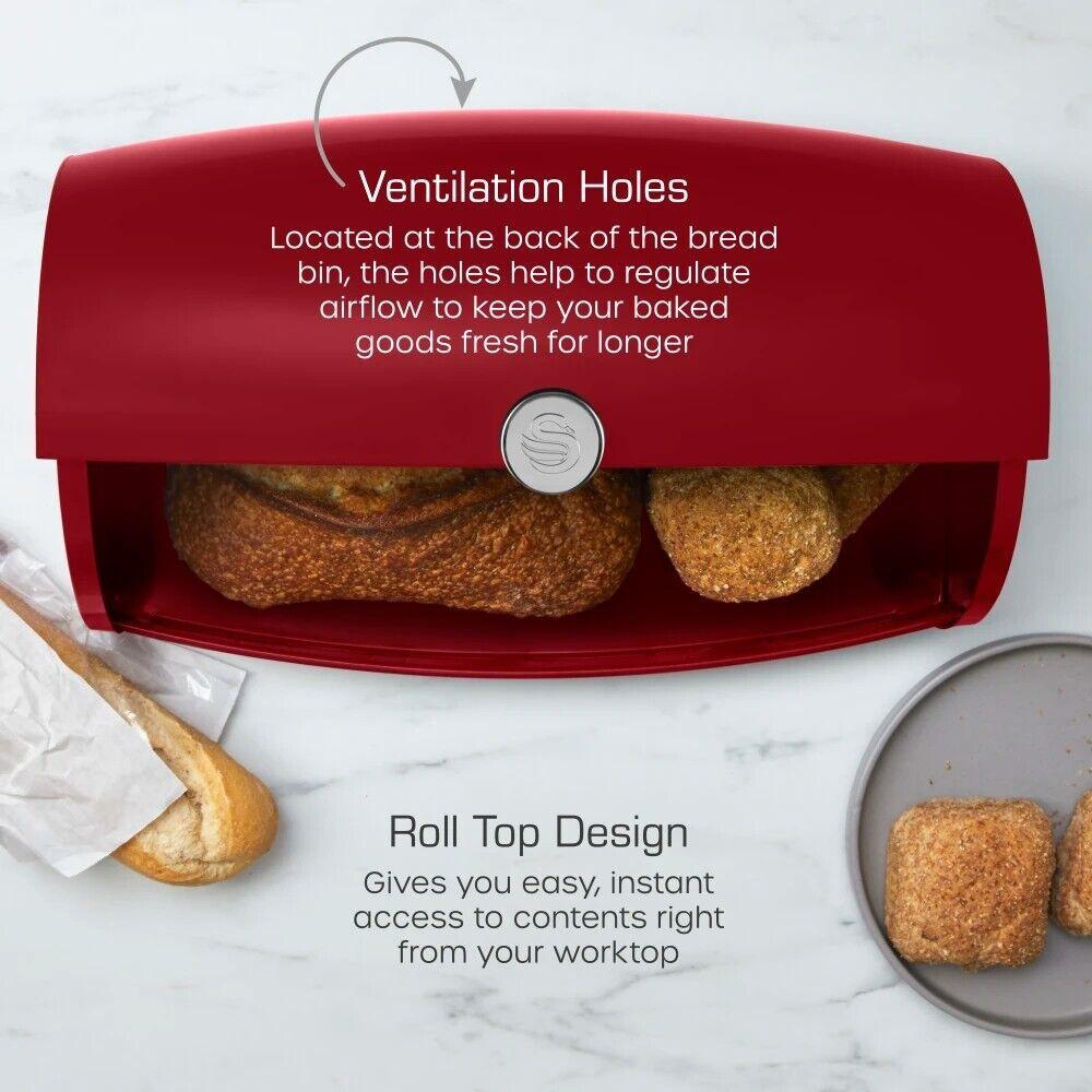 Red bread bin with vented roll-top lid, storing baked rolls