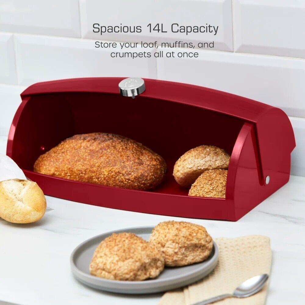 Red bread bin with roll-top lid open, holding several loaves