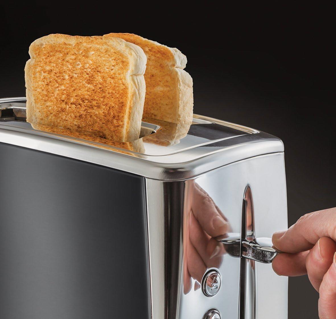 Russell Hobbs grey toaster with bread in slots and side lever being pressed