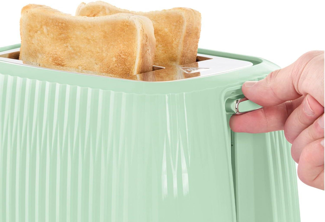 Mint green 2-slice toaster with bread popped up in the warming slot