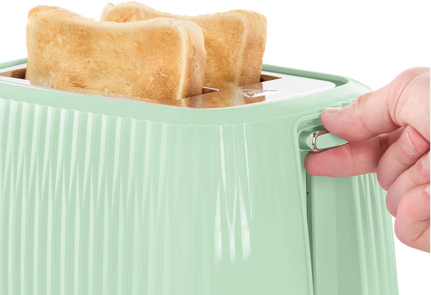 Mint green 2-slice toaster with bread popped up in the warming slot