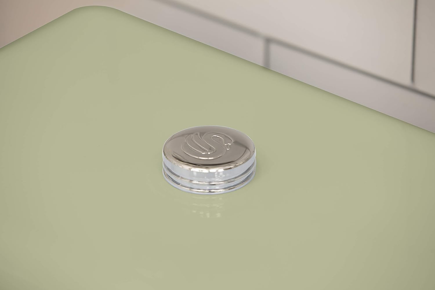 Green bread bin lid with silver ridged ring and embossed swan logo