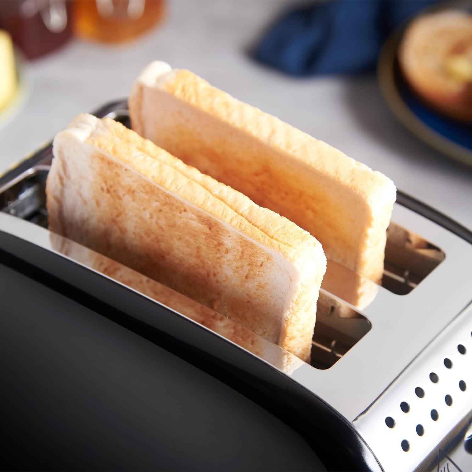Two bread slices toasting inside a black 2-slice toaster