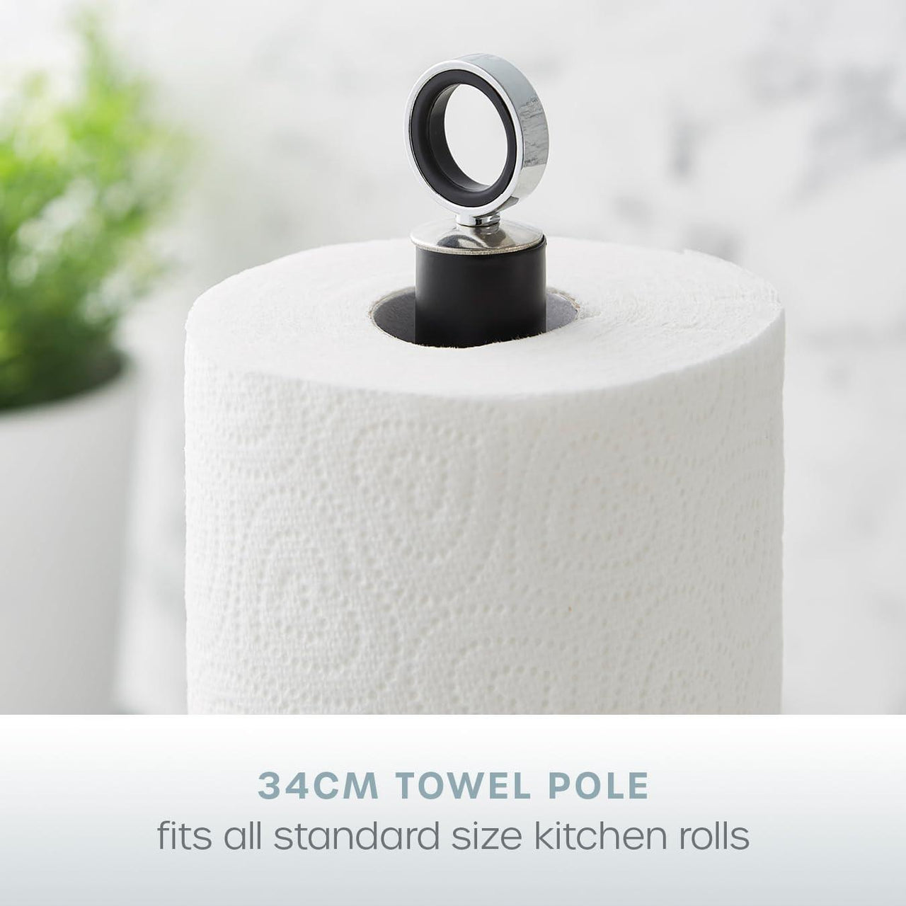 Black towel pole with chrome ring top and kitchen roll held on a central stand
