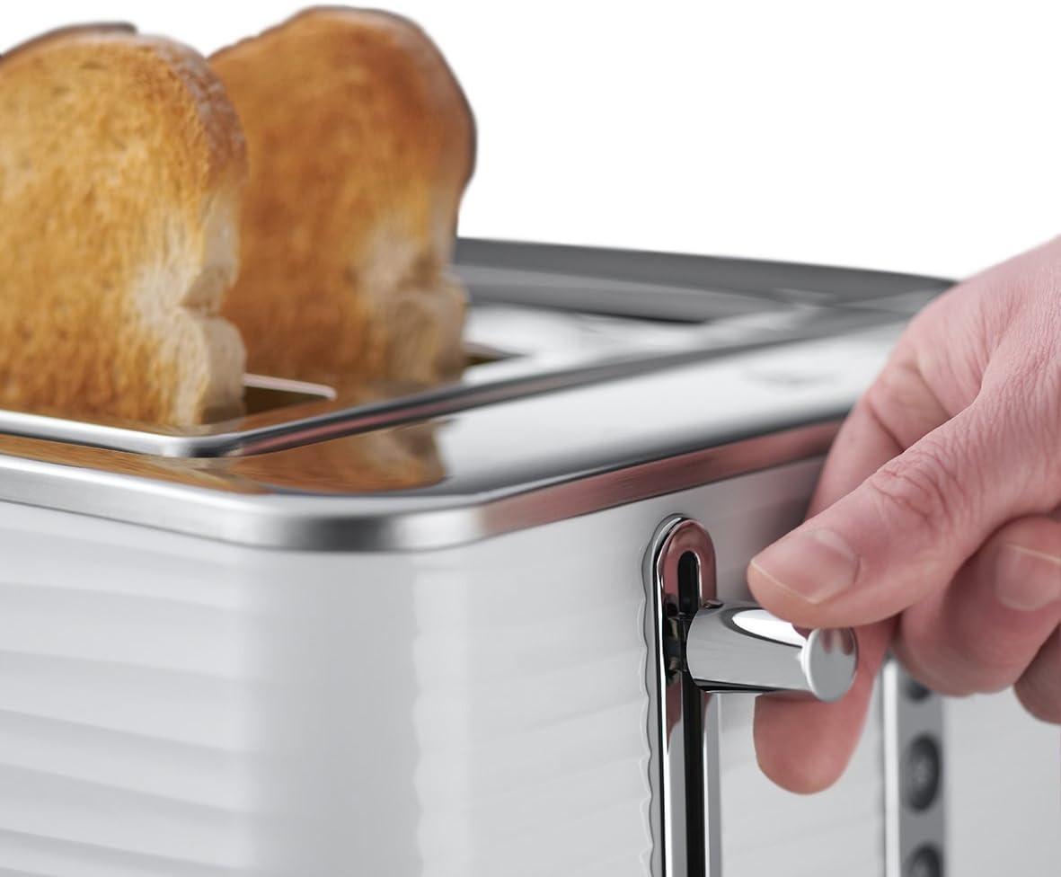 White toaster with lever pressed, showing bread in the slots