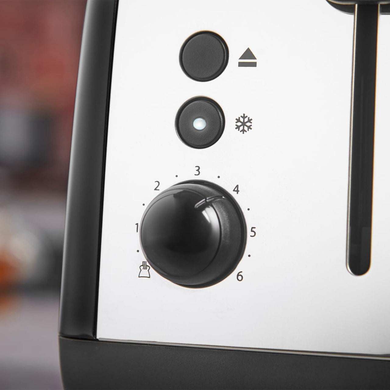 Toaster control dial and buttons on the white panel with icons