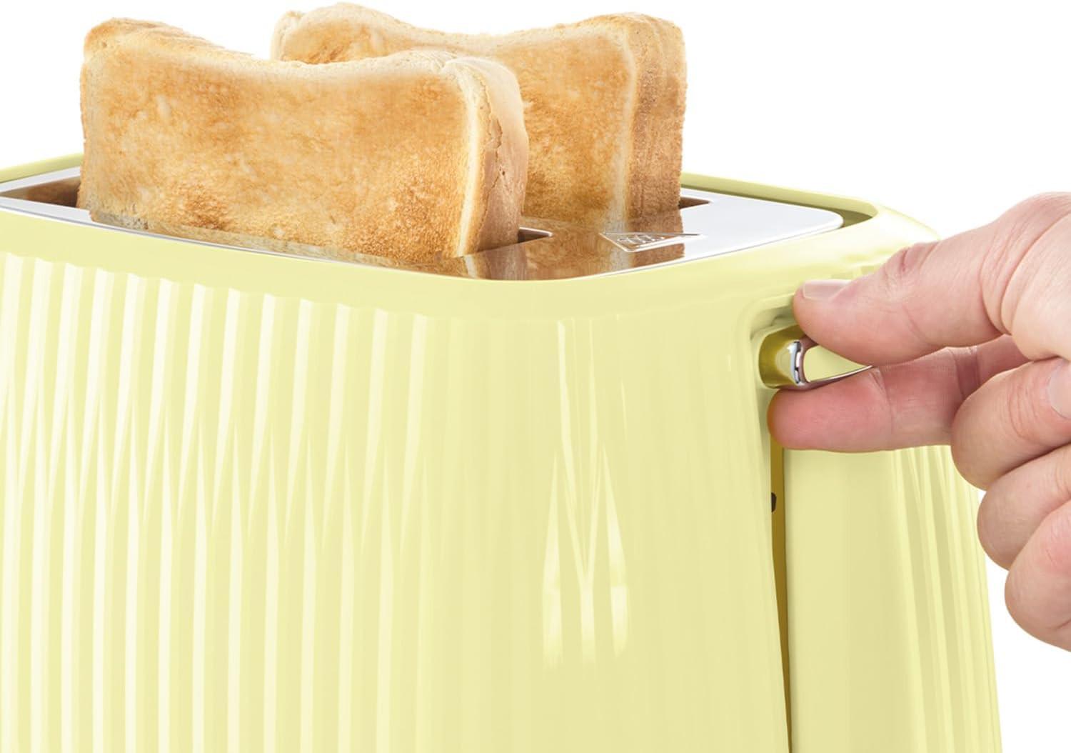 Lemon 2-slice toaster with bread down in slots, hand lifting lever