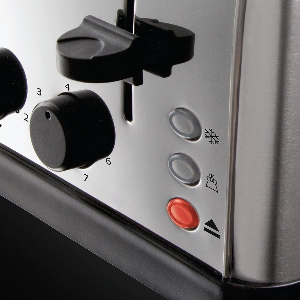 Silver toaster control panel with black knobs, icons, and red cancel button