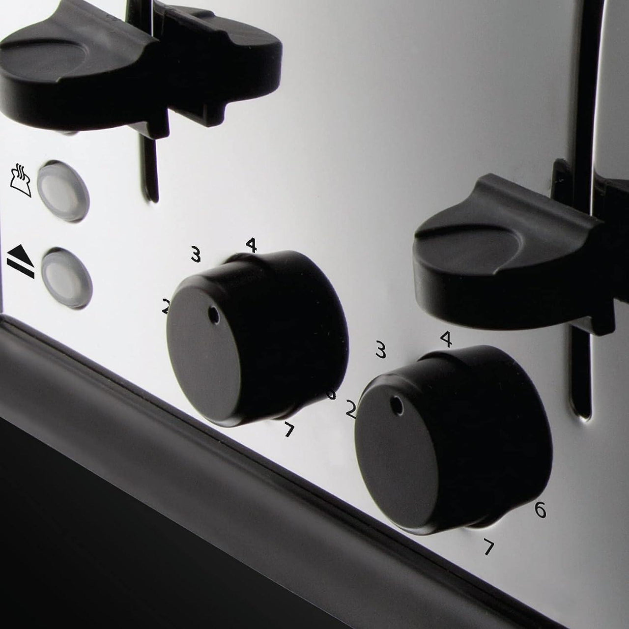 Silver toaster control dials and black lever handles on the front panel