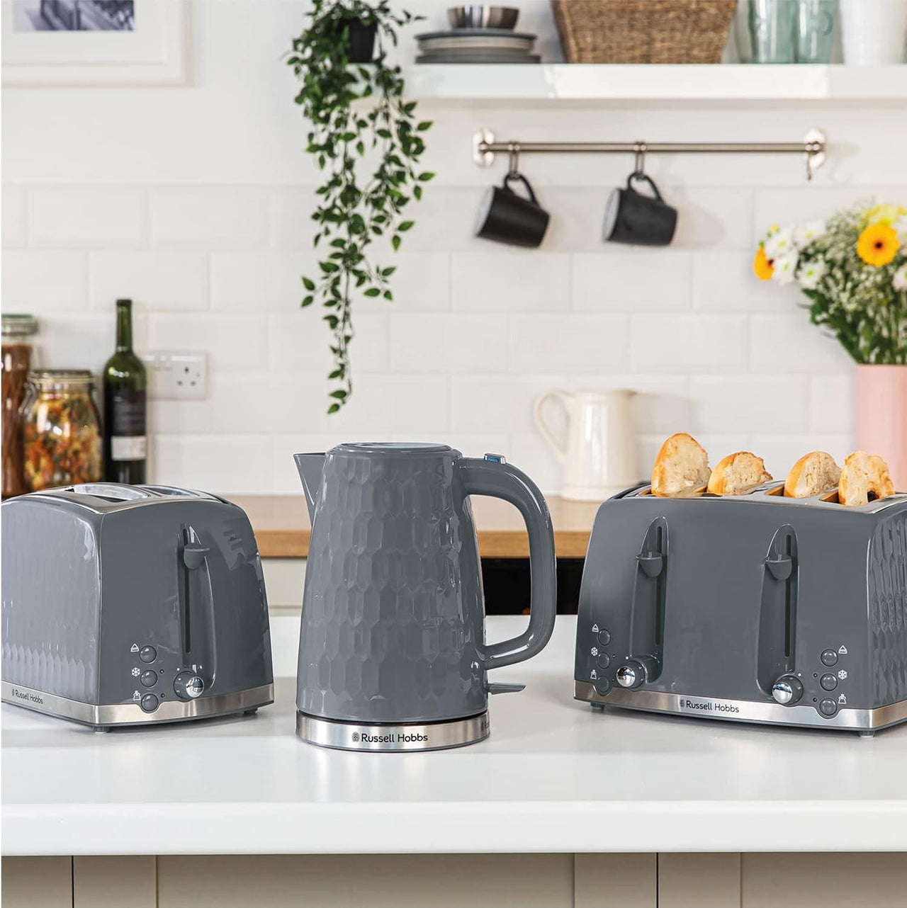 Grey 2-slice honeycomb toaster on kitchen counter with another appliance nearby