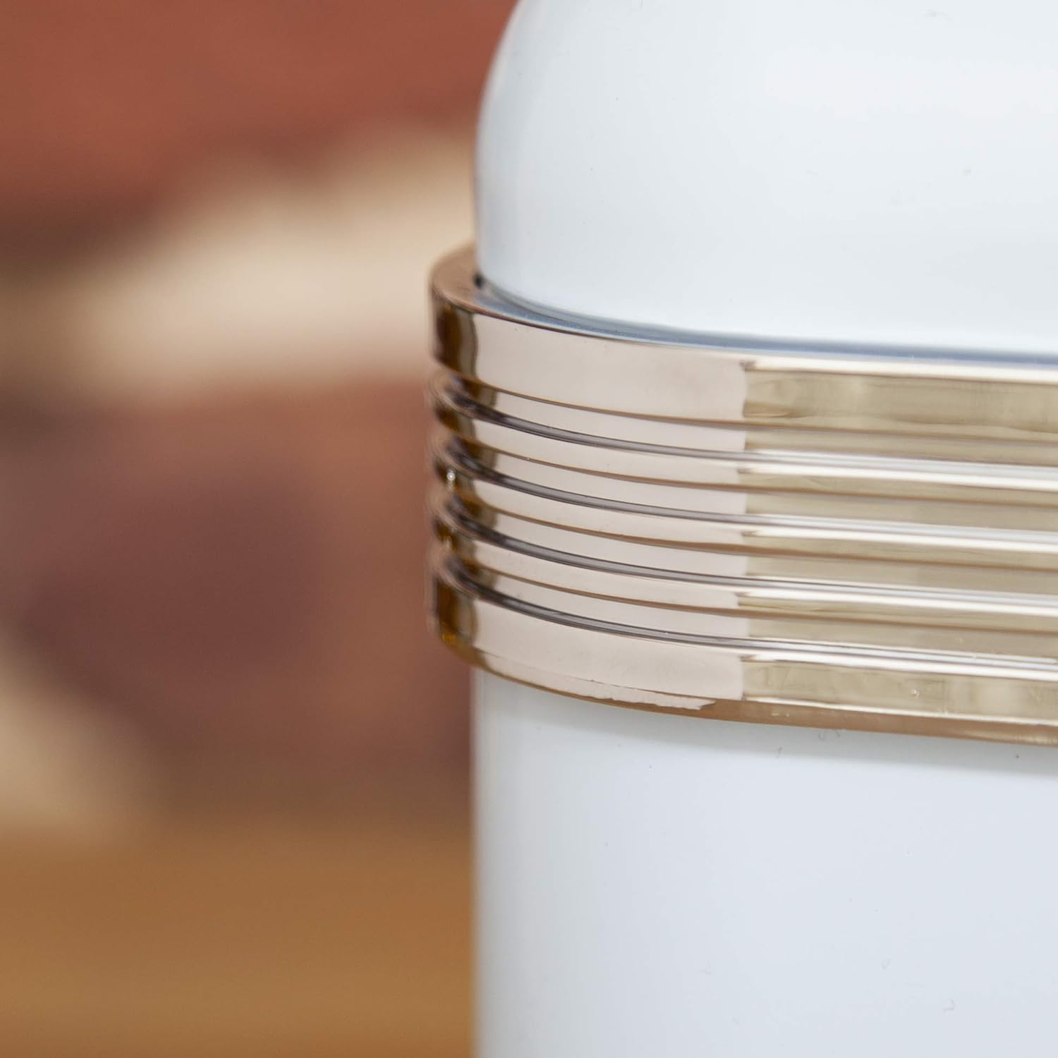 Blue bread bin side with gold-tone metal trim and stacked lid edge detail