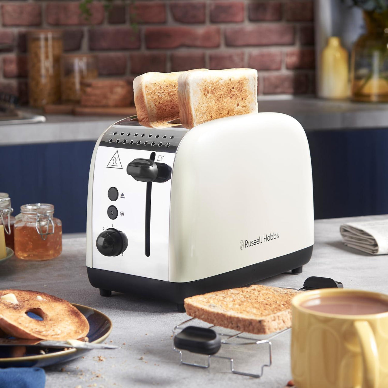 Jasmine cream 2-slice toaster with raised bread and visible black base stand.