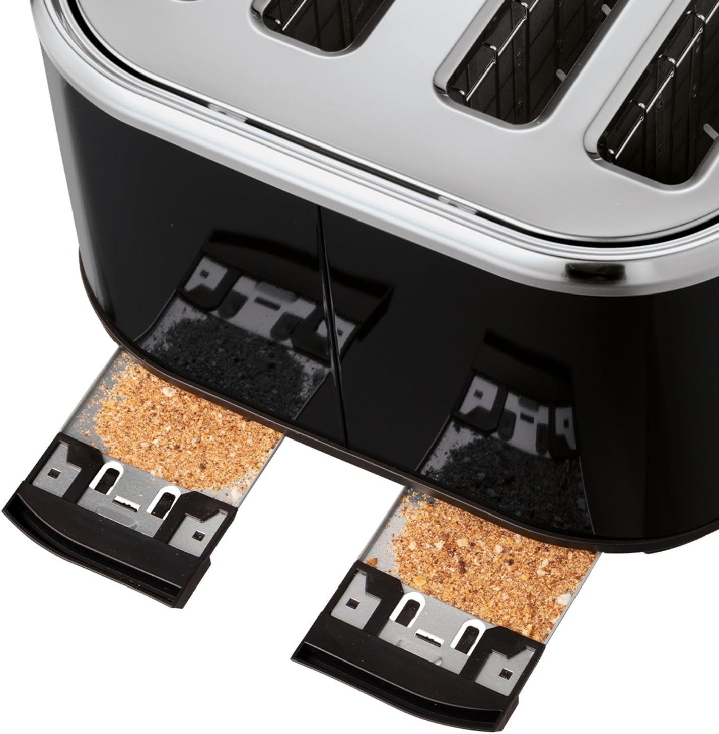 Black toaster crumb tray with loose crumbs pulled out from under the slots