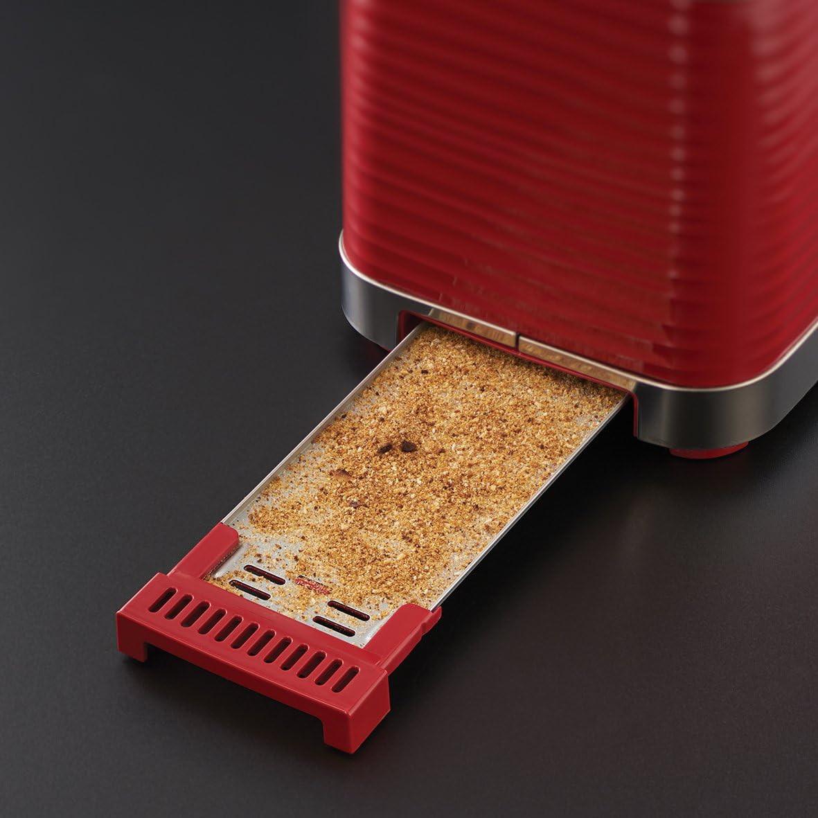 Red toaster with one slice lifted from the slot over the crumb tray