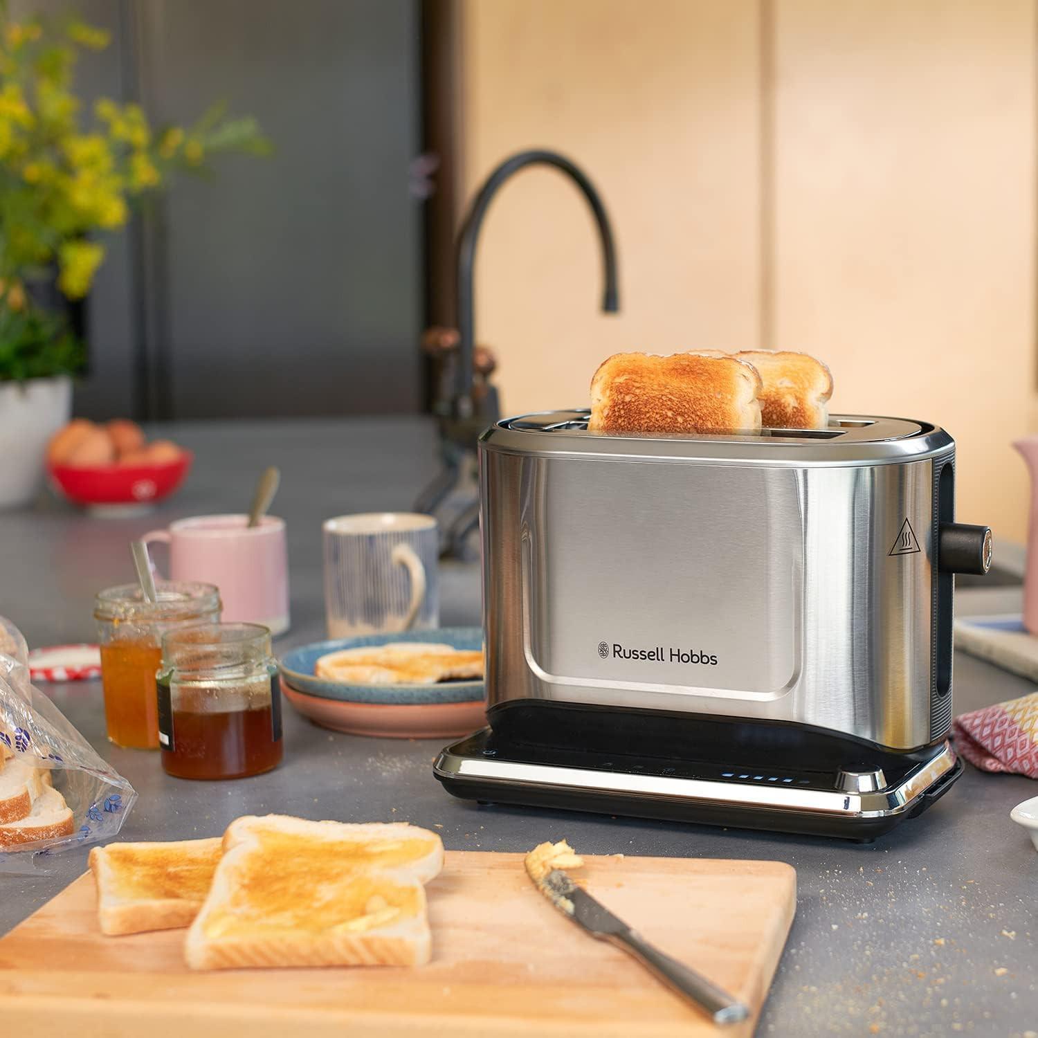 Stainless steel 2-slice toaster on kitchen counter with bread in slots