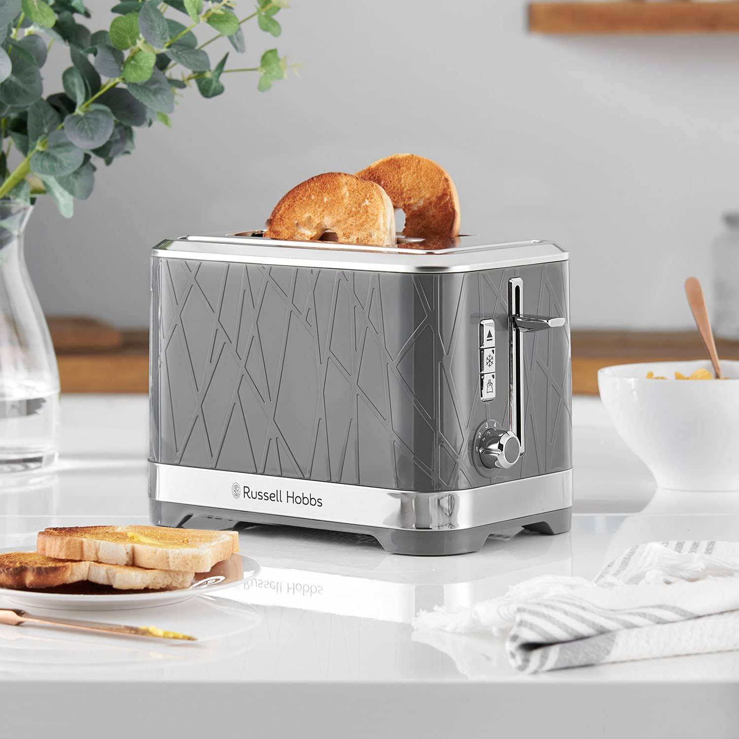 Grey 2-slice toaster with toast in the open slots and chrome control lever