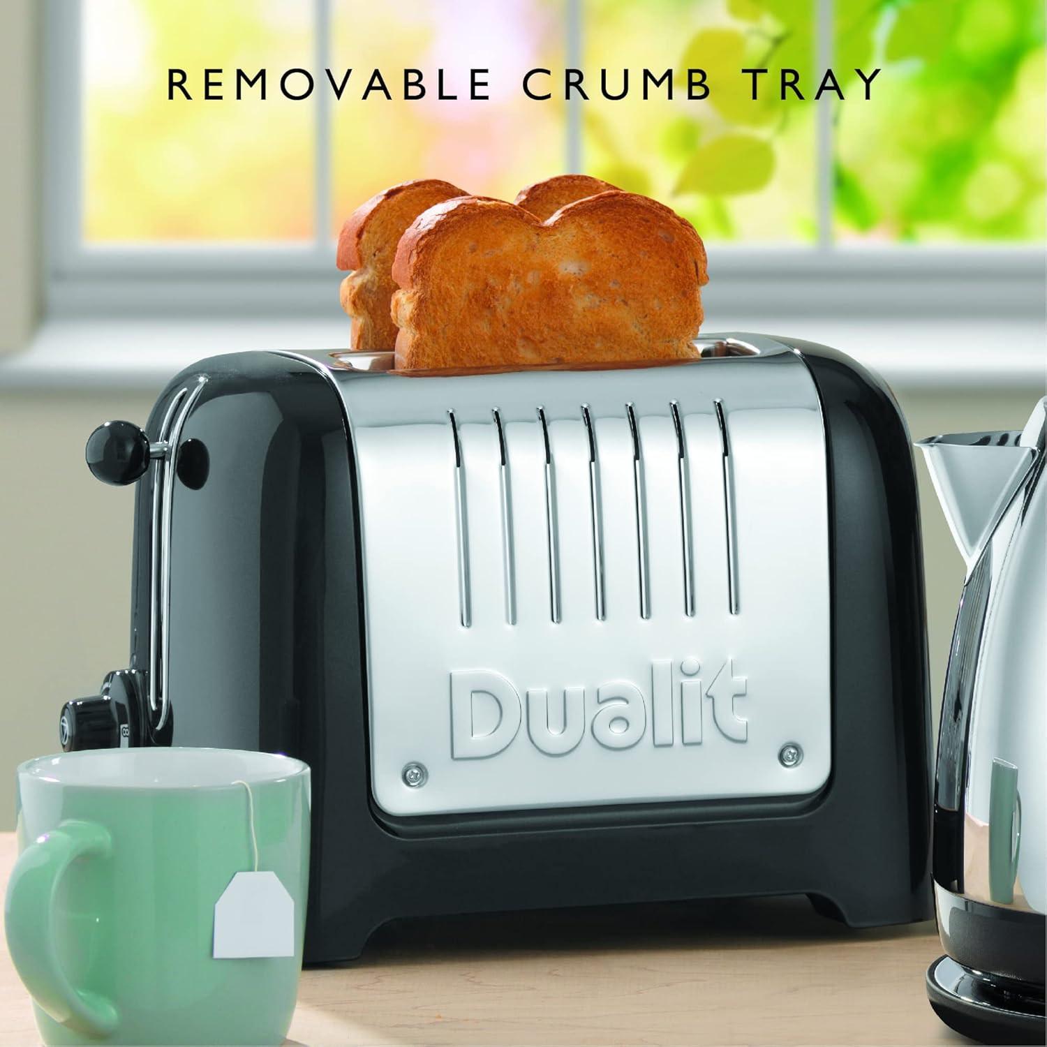 Black Dualit 2-slice toaster with removable crumb tray feature shown with bread inside