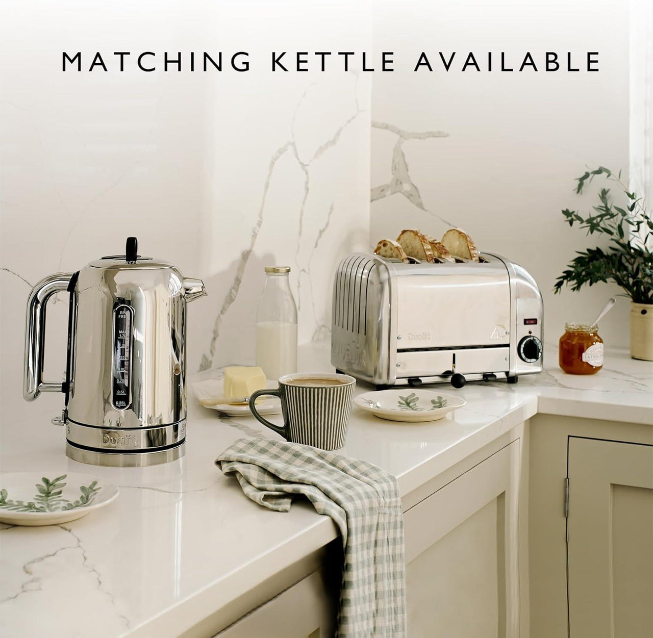 Stainless steel 4-slice toaster on countertop next to a kettle on a kitchen counter