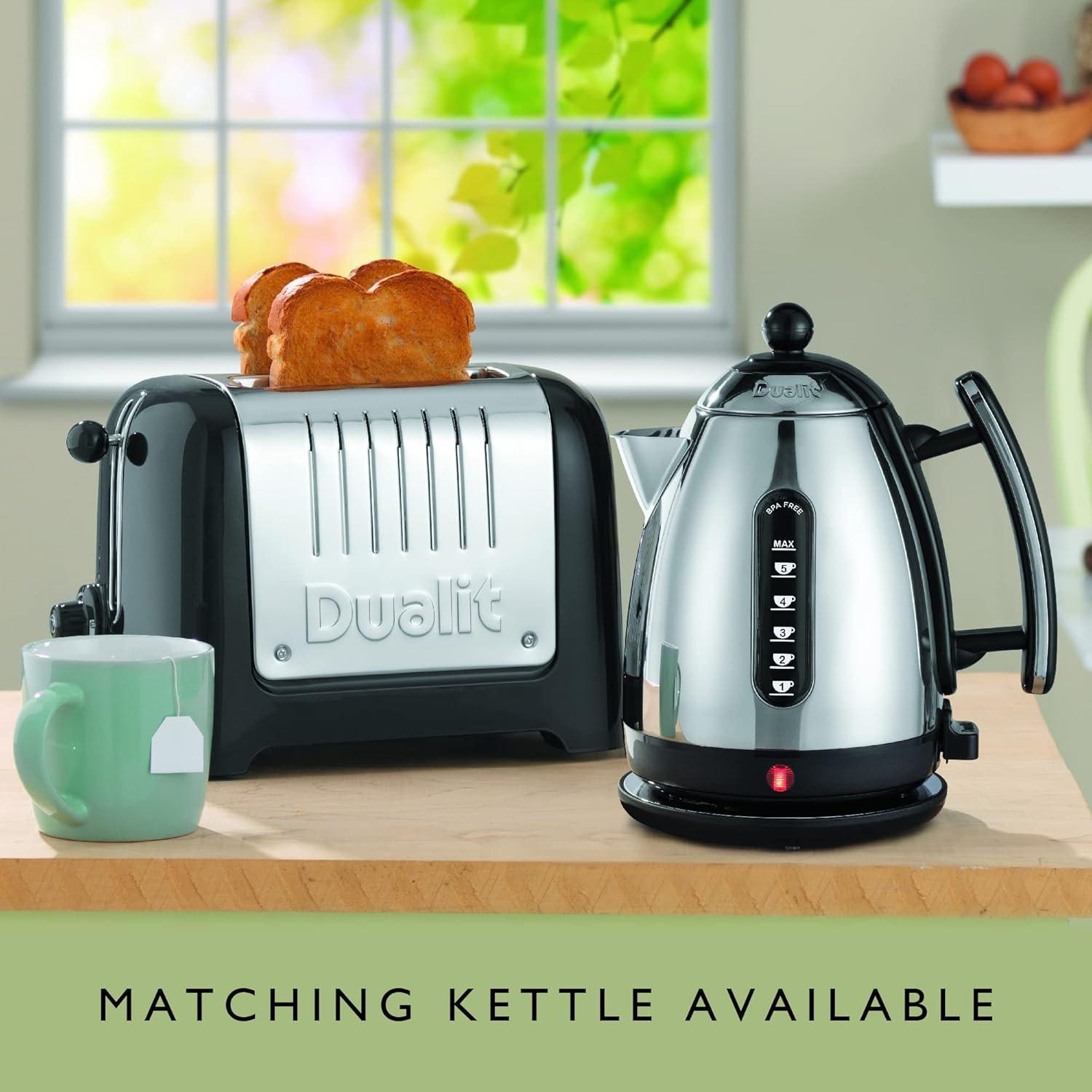 Black Dualit toaster on countertop with bread visible inside the extra-wide slots