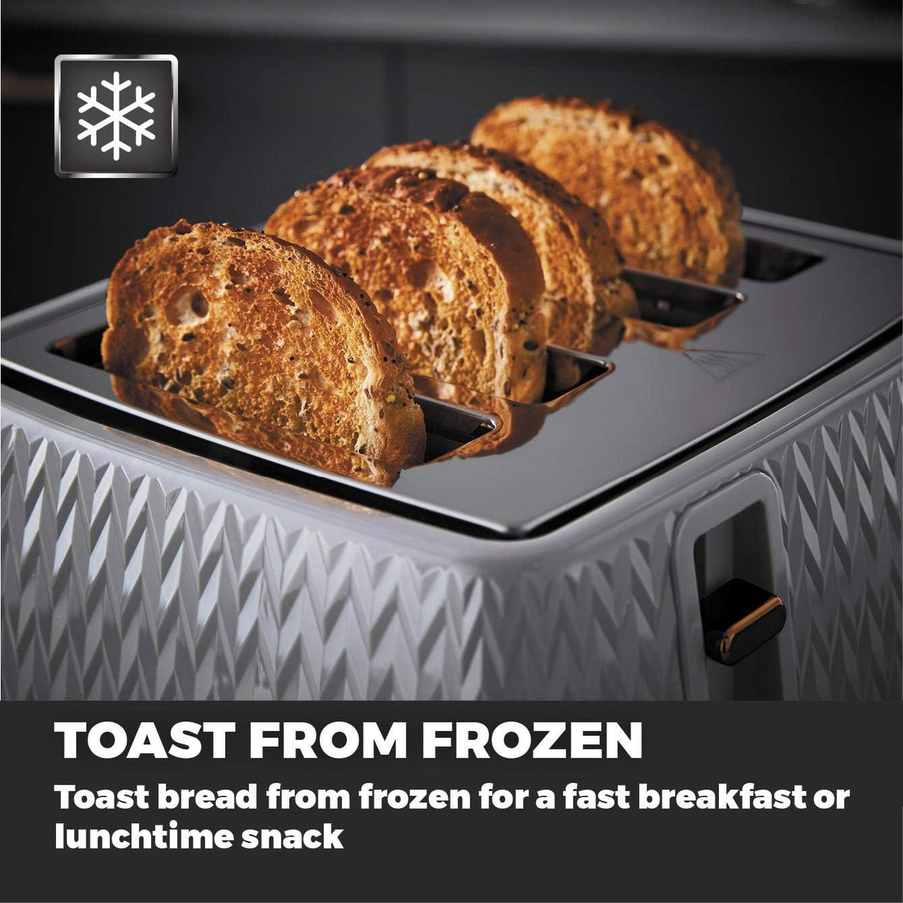 Toaster with golden bread slices on crumb tray, chevron grey casing and levers