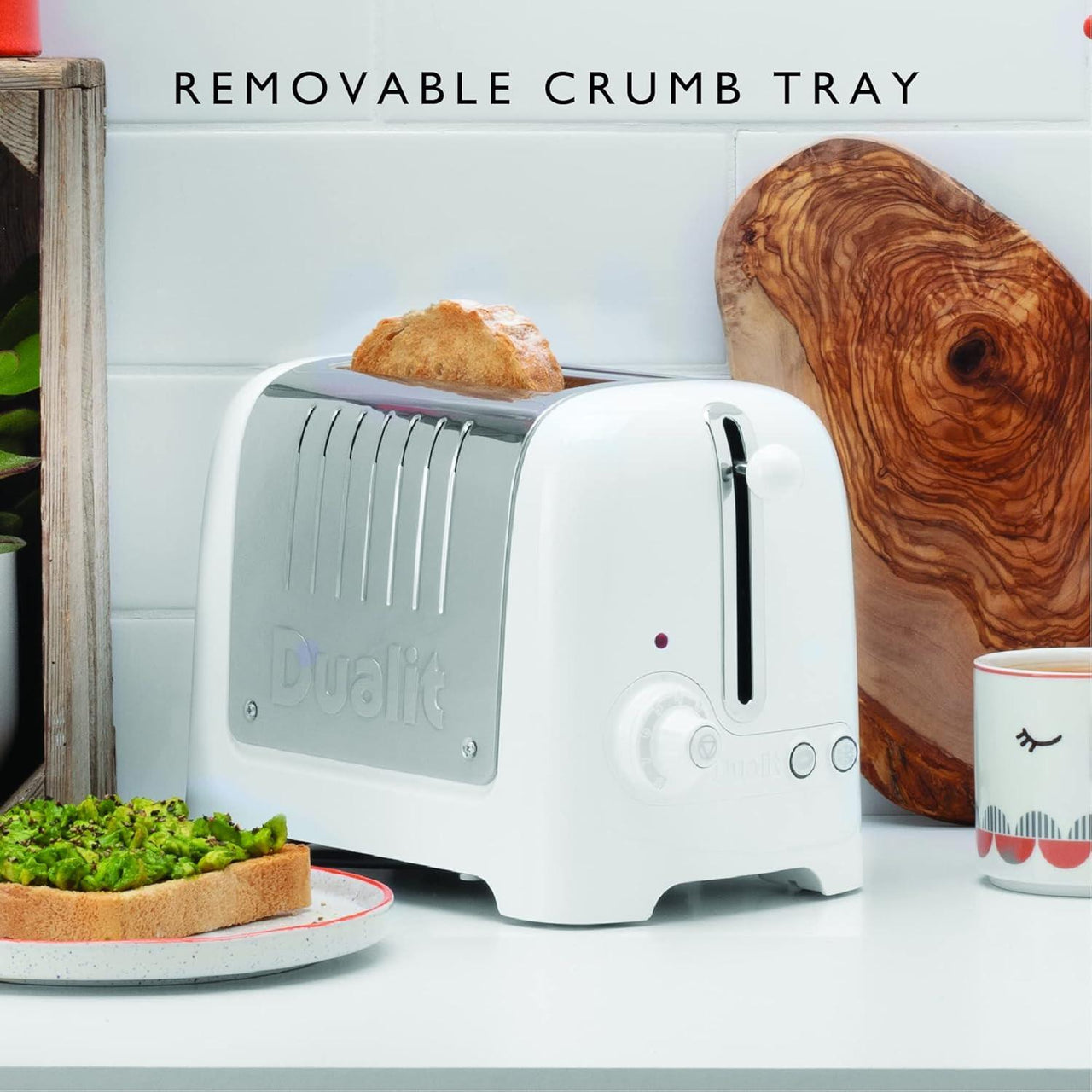 White Dualit Lite toaster with removable crumb tray slid out for cleaning, side view
