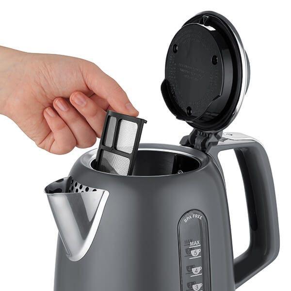 Grey electric jug kettle with open lid and pour spout, shown with hand