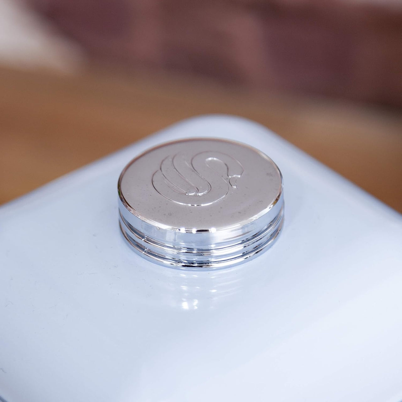 Blue bread bin lid with embossed Swan logo on round metal knob