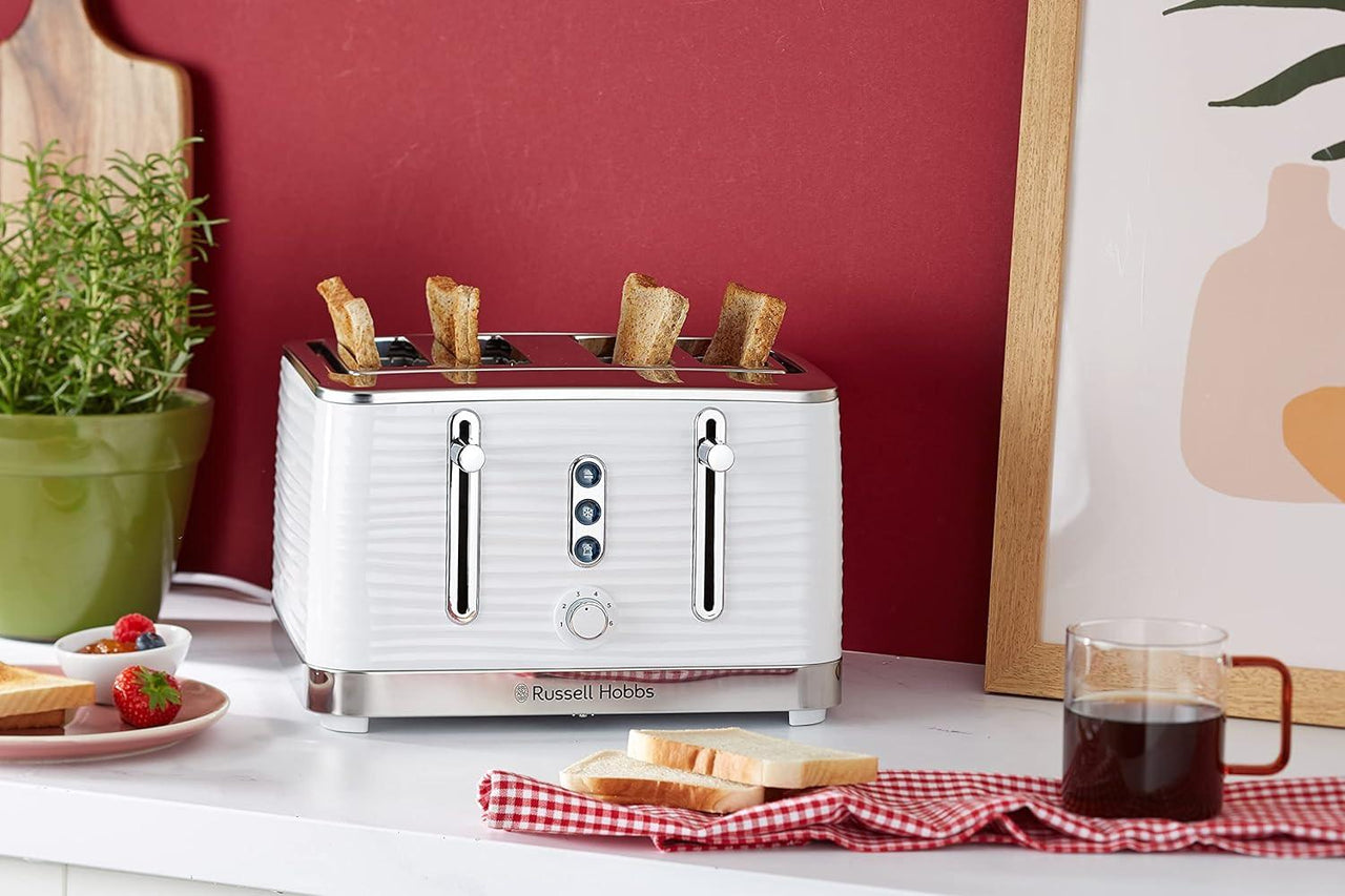 White 4-slice toaster with toast rising above the slots and front control dial