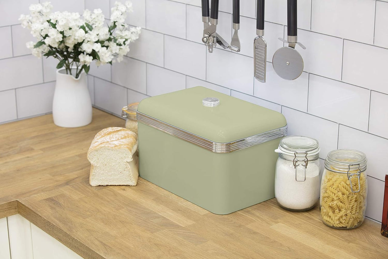 Green bread bin on kitchen counter with matching lidded canisters and glass jars