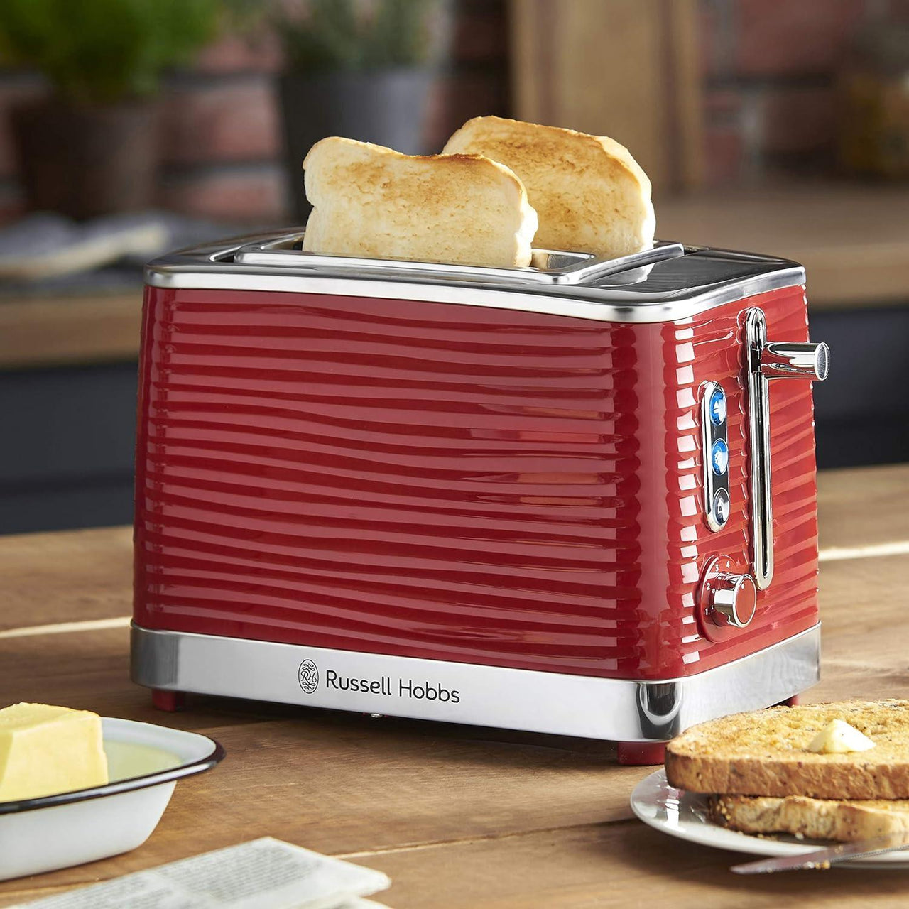 Red 2-slice toaster with two bread slices in the slots