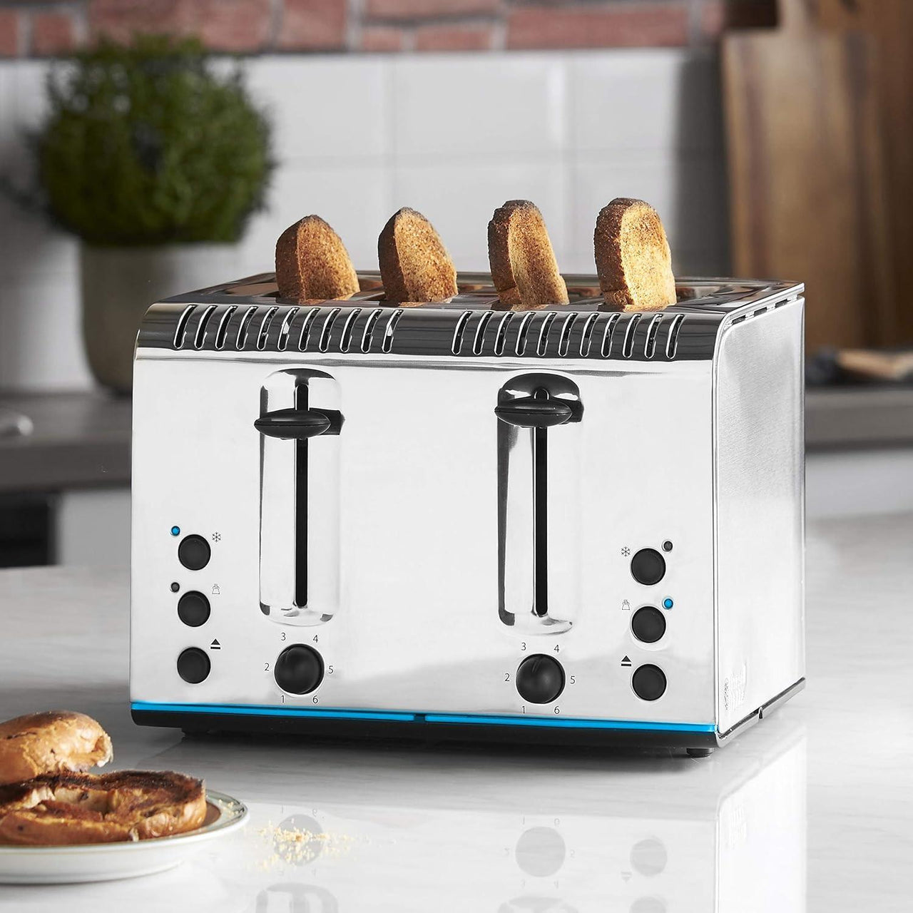 Stainless steel 4-slice toaster with four slices of bread popped up