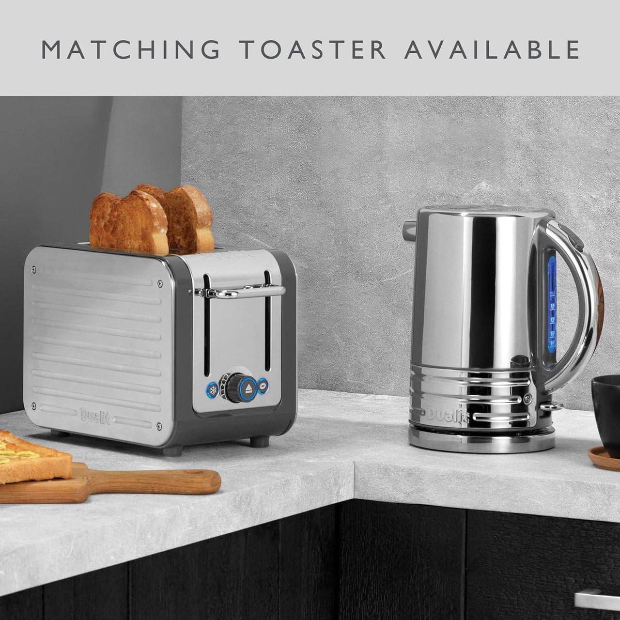 Black 2-slice toaster with matching toaster and kettle setup on countertop.