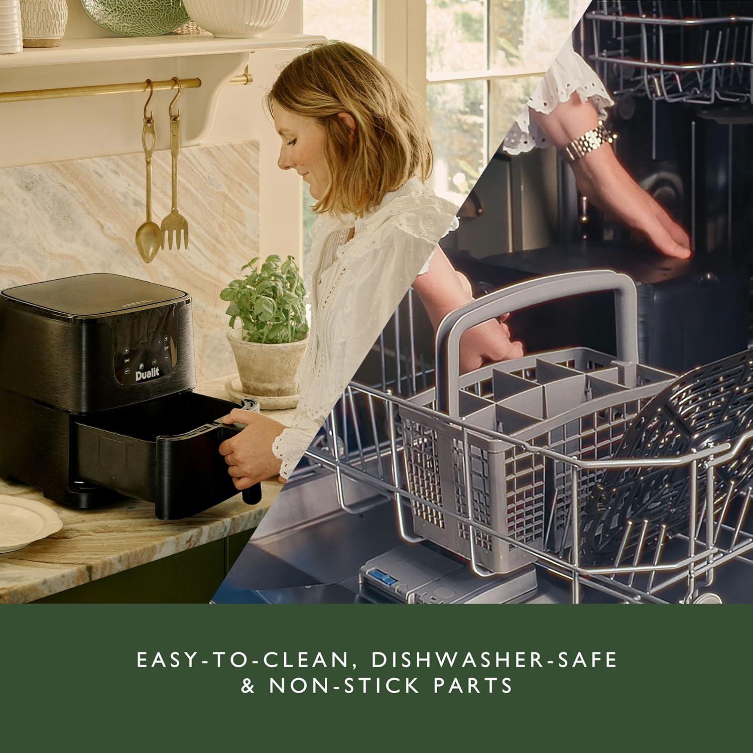 Black Dualit air fryer on countertop with basket being lifted for serving.