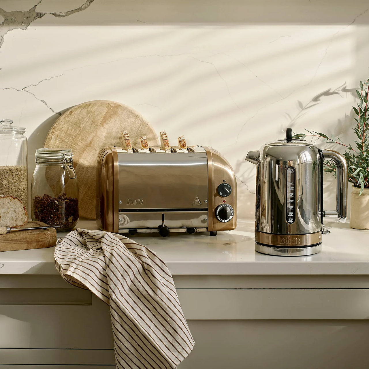 Copper 4-slice toaster on countertop with lever and control dial visible