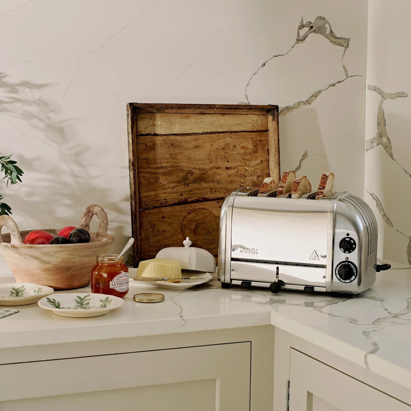 Stainless steel 4-slice toaster with front controls on countertop